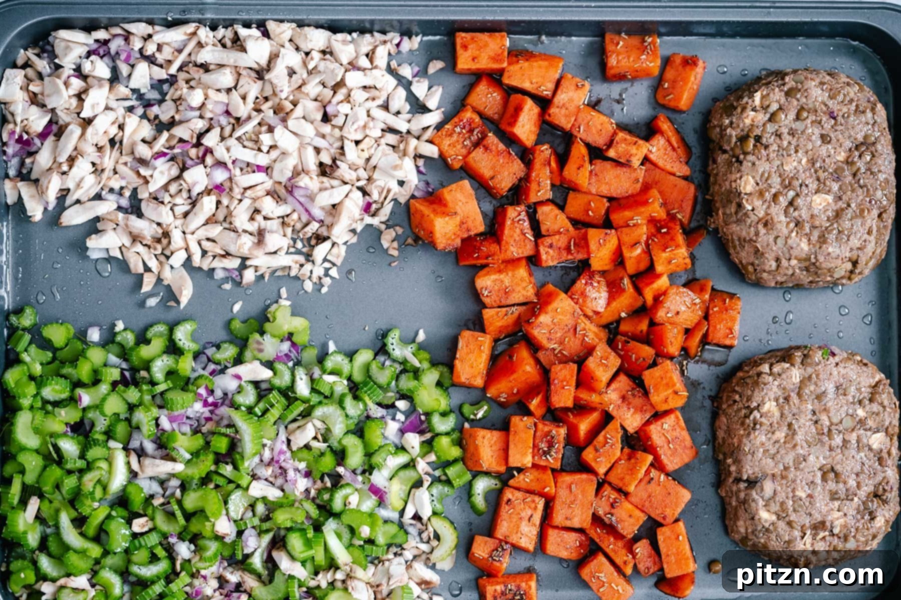 Assembling the Thanksgiving Sheet Pan Dinner Overhead shot of two vegan lentil loaves being carefully placed onto a baking sheet, arranged with various side dishes for the Thanksgiving meal.