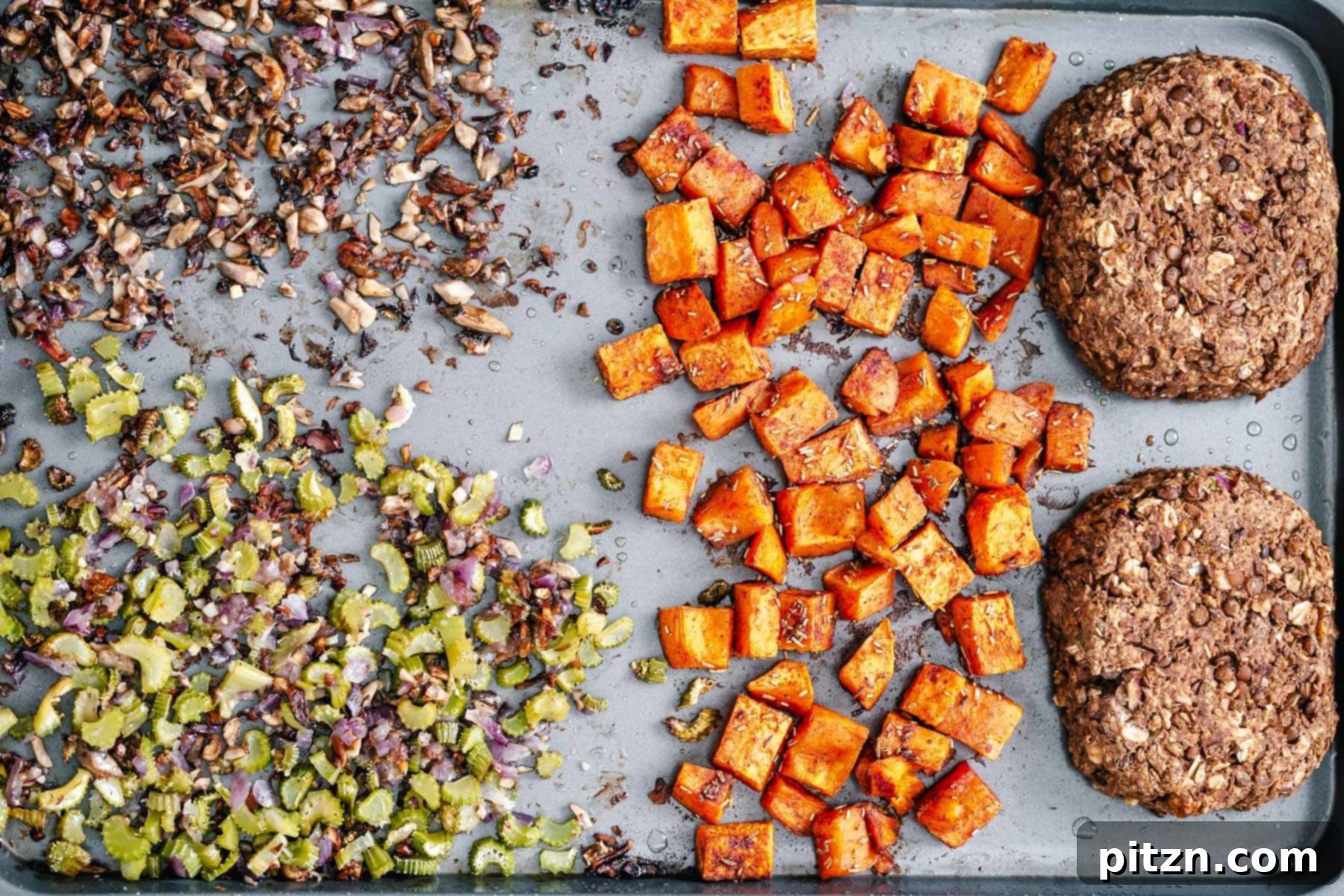 Partially Baked Vegan Thanksgiving Dinner An overhead shot of a partially baked vegan Thanksgiving sheetpan dinner, with sweet potatoes removed and other components starting to brown.