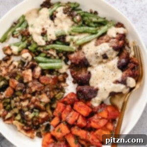 One-Pan Vegan Thanksgiving Feast 2 A beautifully presented vegan sheet pan Thanksgiving dinner, featuring a hearty lentil loaf, roasted sweet potatoes, and green beans.