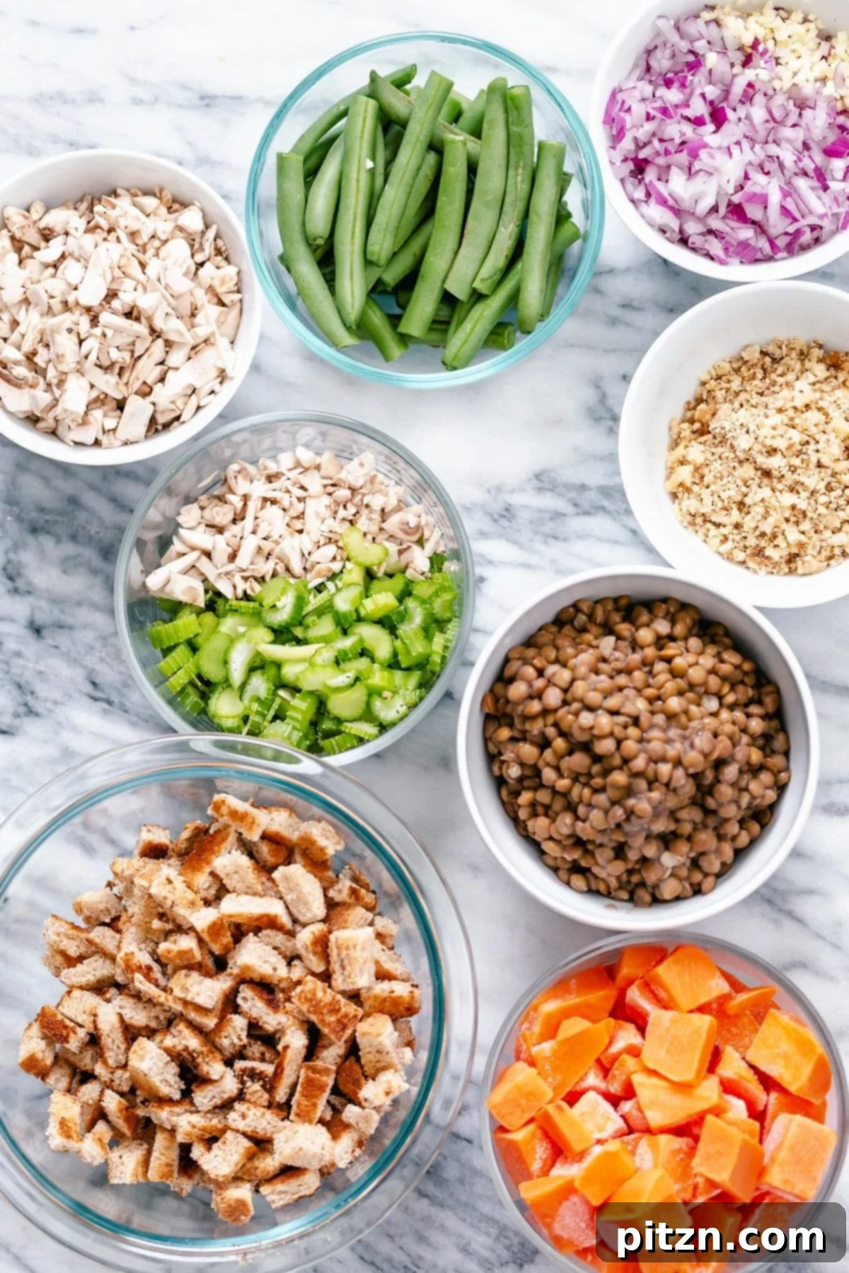 Ingredients for Vegan Thanksgiving Feast A collection of fresh ingredients laid out, including lentils, walnuts, herbs, sweet potatoes, and green beans, ready for the Vegan Thanksgiving Sheet Pan Dinner.