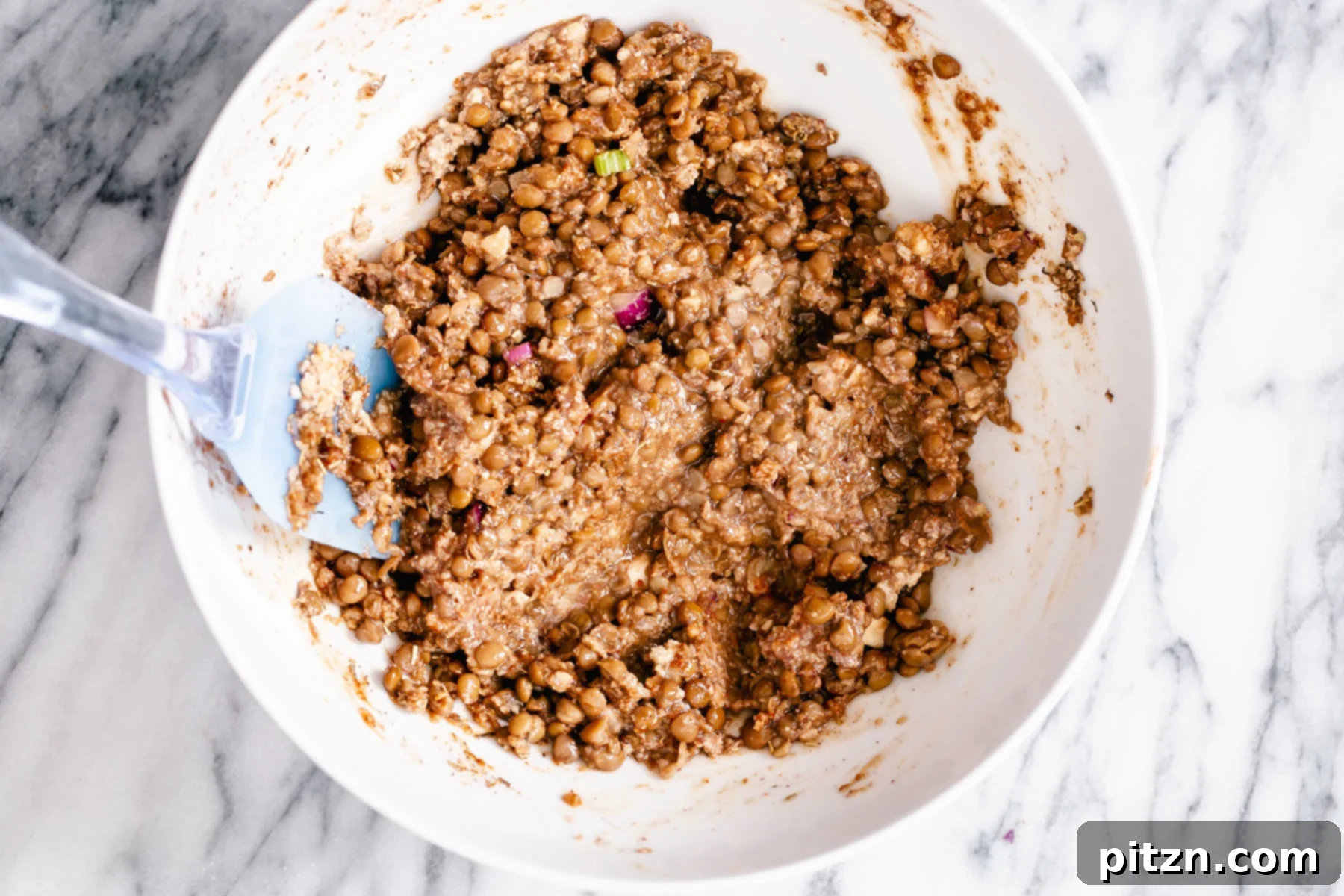 Lentil Loaf Mixture The fully mixed lentil meatloaf mixture resting in a white bowl, ready to be shaped.