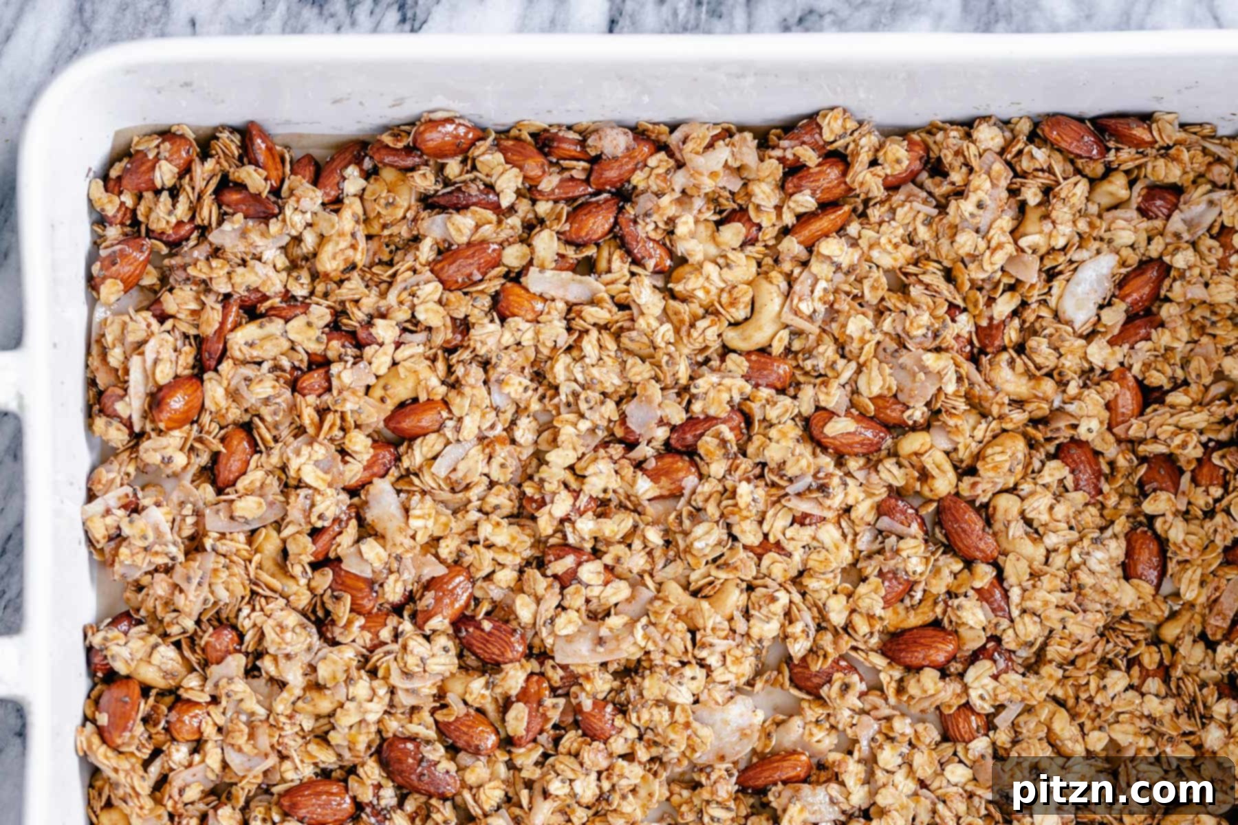 Granola in Ceramic Dish Overhead shot of a casserole dish with baked almond coconut granola