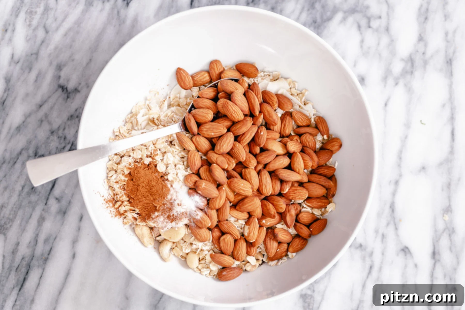 Dry Granola Mix A small bowl with dry ingredients needed for making vegan baked almond coconut granola