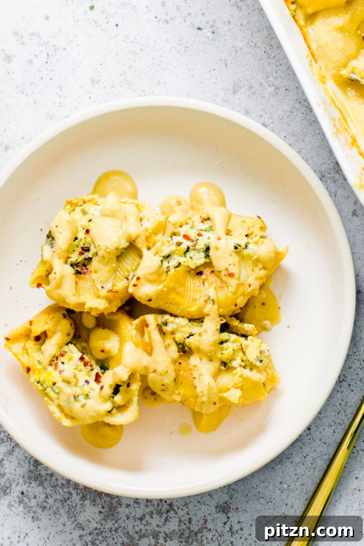 Vegan Stuffed Shells Plated A perfectly plated serving of vegan butternut squash and tofu ricotta stuffed shells on a white dish, garnished and ready.