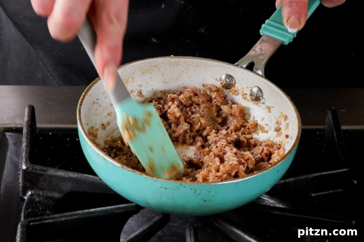 The German chocolate cookie filling in the pan after cooking, showcasing its thick, glossy, and caramel-like texture.