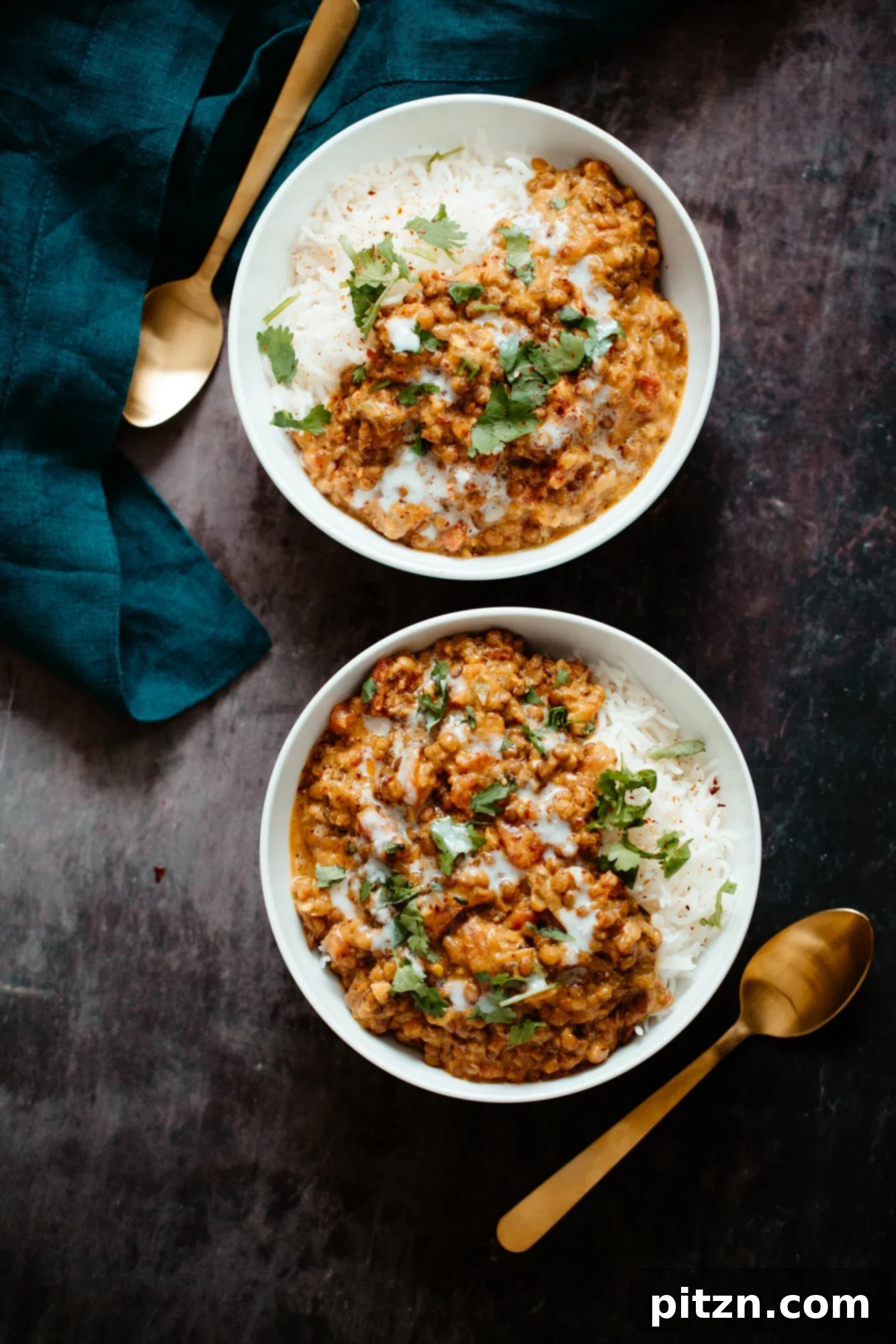 Vegan Curry Lentil Casserole Two bowls of rice topped with creamy coconut curry lentil casserole, garnished with fresh cilantro.