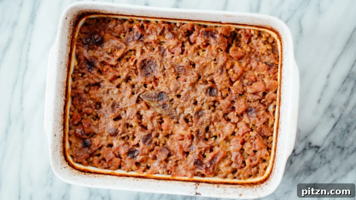 Baked Lentil Casserole A freshly baked vegan Indian Curry Lentil Casserole, vibrant and bubbling, just removed from the oven and ready for its final touches.