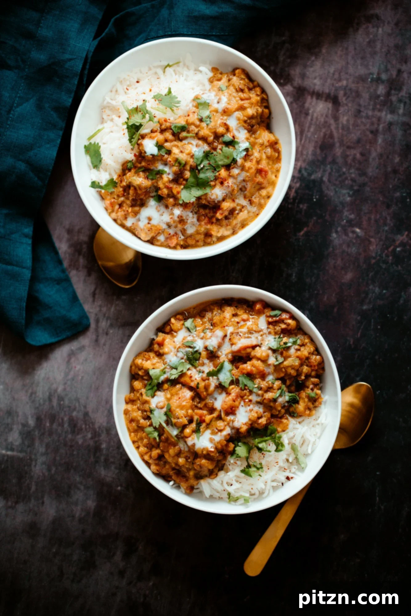 Lentil Casserole Served with Rice Two pristine white bowls generously filled with fluffy rice and topped with the rich, vegan Indian Curry Lentil Casserole, garnished for serving.