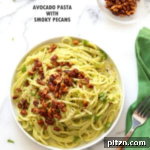 Veganuary Dash: 15 Quick 30-Minute Plant-Powered Meals 10 Creamy Avocado Pasta with Smoky Pecans, served over spaghetti with fresh herbs.