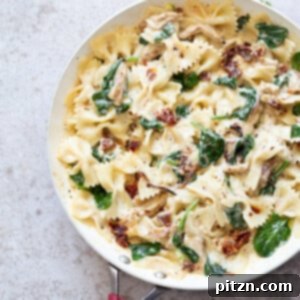 Veganuary Dash: 15 Quick 30-Minute Plant-Powered Meals 12 Creamy Sun Dried Tomato Pasta with Garlic Soy Curls, showcasing a rich sauce and savory protein.