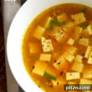 Veganuary Dash: 15 Quick 30-Minute Plant-Powered Meals 3 A bowl of Turmeric Miso Soup with Ginger, Garlic, and Tofu, garnished with fresh herbs.