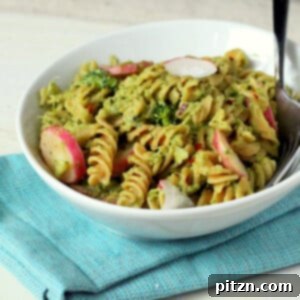 Broccoli and basil pesto fusilli pasta served with red radish slices