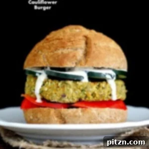 Artichoke Spinach Cauliflower Bean Burgers on a bun with toppings