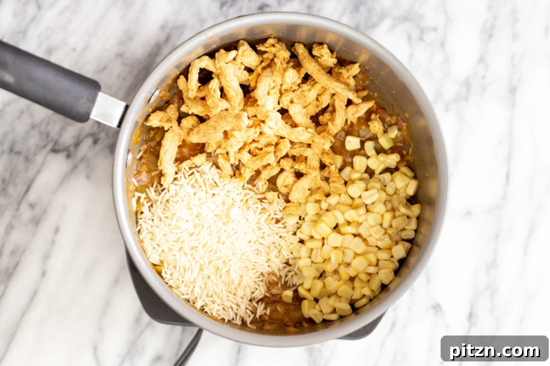 combining main ingredients rice, soy curls, and corn being added to a pot with the green chile and spice mixture for vegan enchilada soup