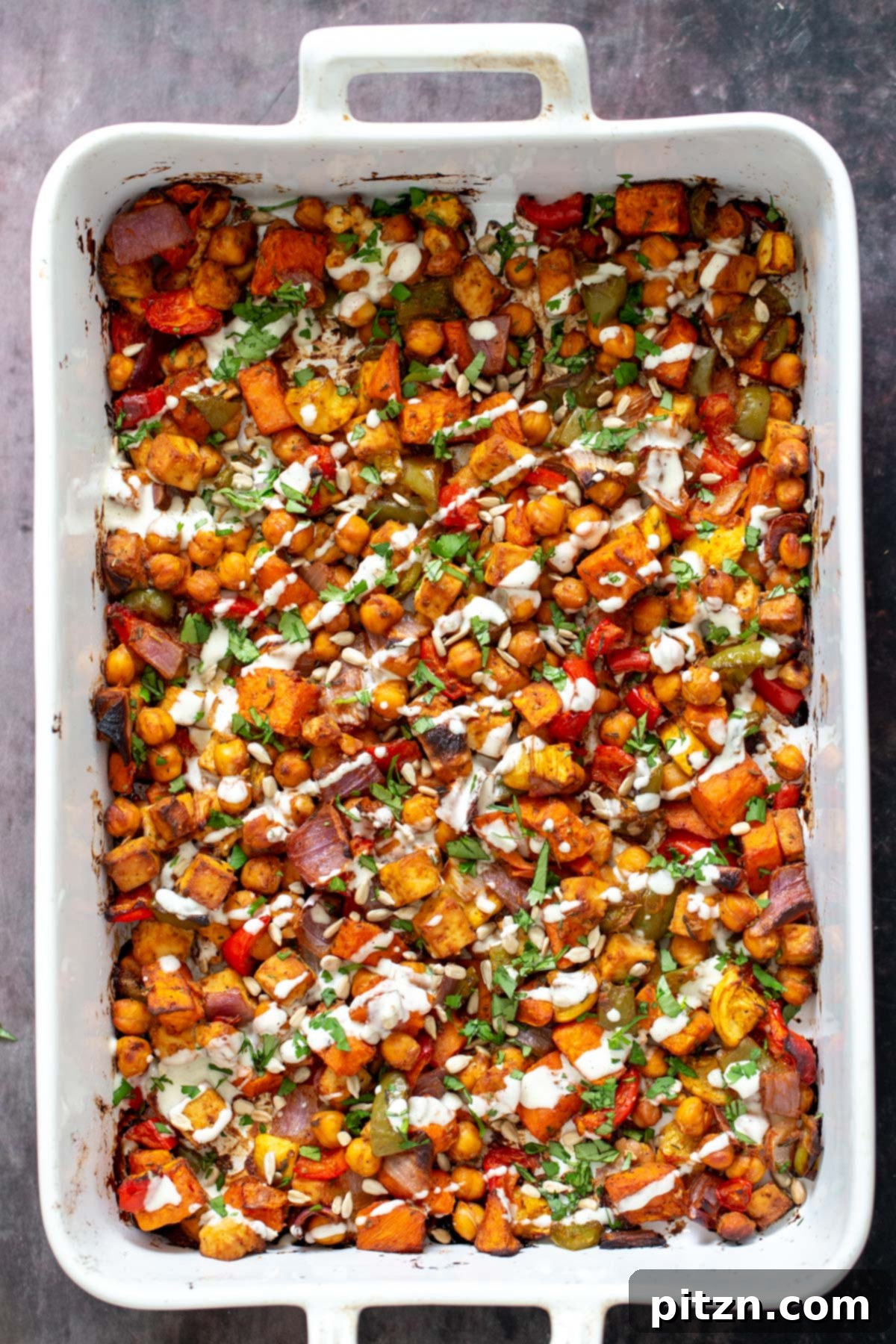 Cheeseburger Sheet Pan Veggies with Garlic Aioli 3 Overhead shot of cheeseburger casserole drizzled with vegan mayo made with cashews
