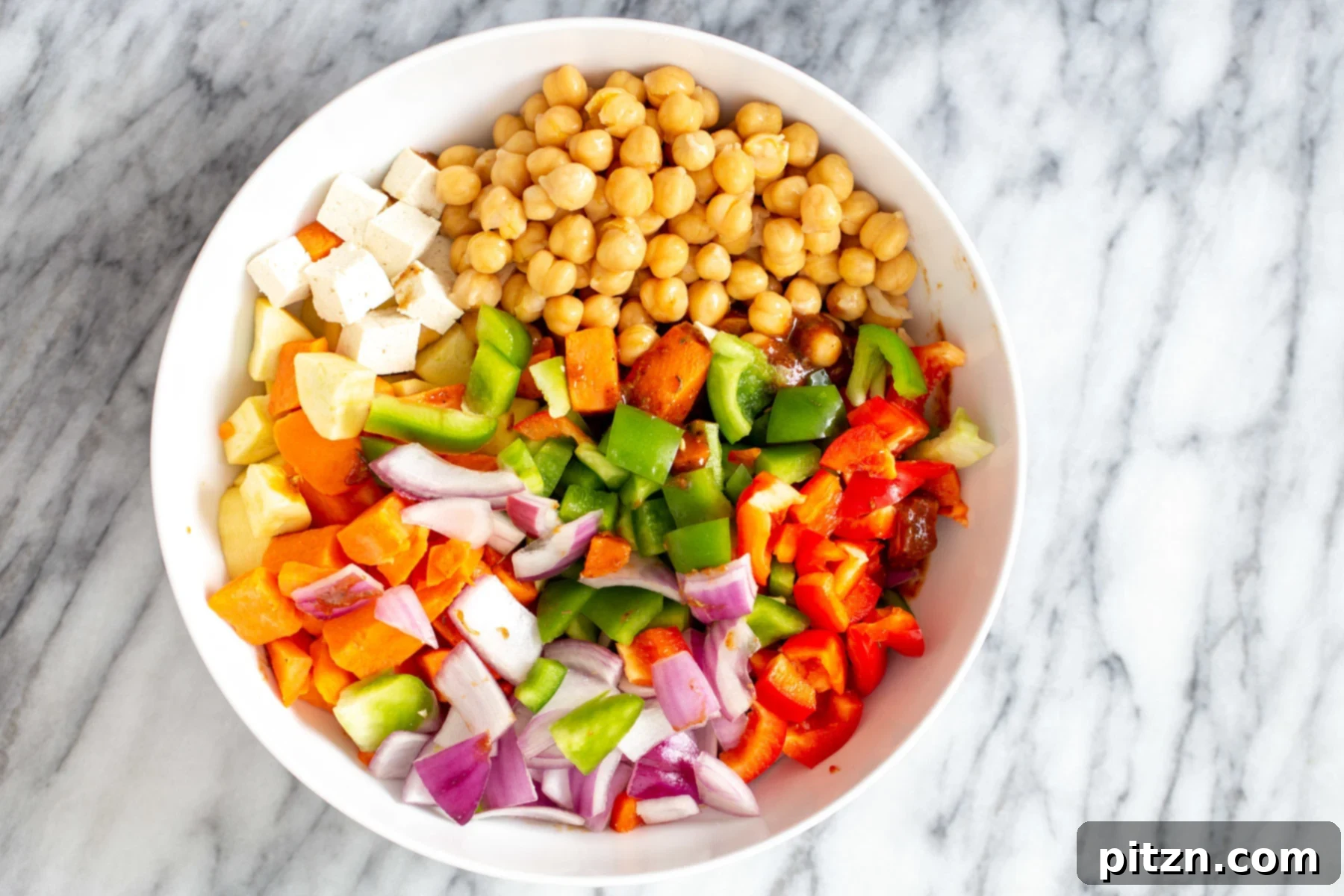 Cheeseburger Sheet Pan Veggies with Garlic Aioli 8 Vegetables and tofu cubes in a small white bowl