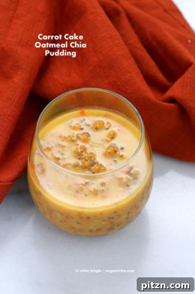 Carrot Cake Chia Pudding beautifully served in a small glass with garnishes like carrot curls and chopped nuts, ready to be enjoyed.