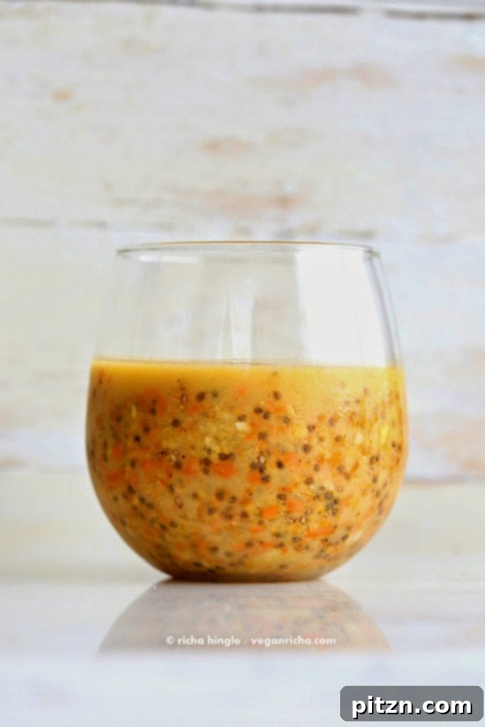Final close-up shot of Carrot Cake Chia Pudding, highlighting the creamy texture, roasted carrot pieces, and inviting presentation in a glass.