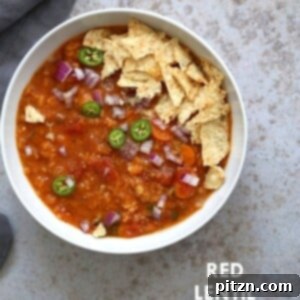 A comforting bowl of Easy Tortilla Soup with Red Lentils, garnished with fresh cilantro and crunchy tortilla chips.