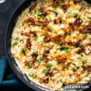 A delectable French Onion Skillet Lasagna bubbling with rich, caramelized onions and vegan béchamel, fresh from the skillet.