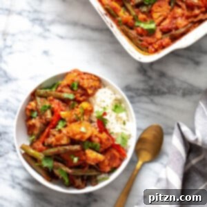A bubbling Baked Veggie Curry Casserole, richly spiced and full of colorful vegetables, fresh from the oven.