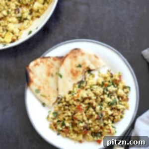 A close-up of Tofu Bhurji, an Indian scrambled tofu dish, garnished with fresh cilantro, ready to be served for a delicious vegan breakfast.