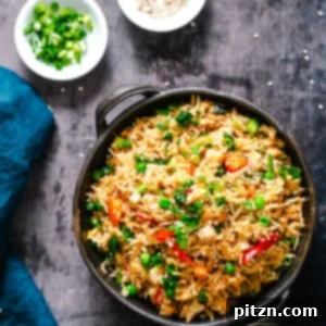 A colorful bowl of Vegan Instant Pot Teriyaki Fried Rice, brimming with vegetables and sesame seeds, ready to be enjoyed as a quick Asian-inspired meal.