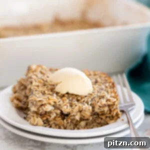 A side view of a generous serving of baked lemon poppy seed oatmeal in a bowl, showcasing its moist texture and golden-brown top.
