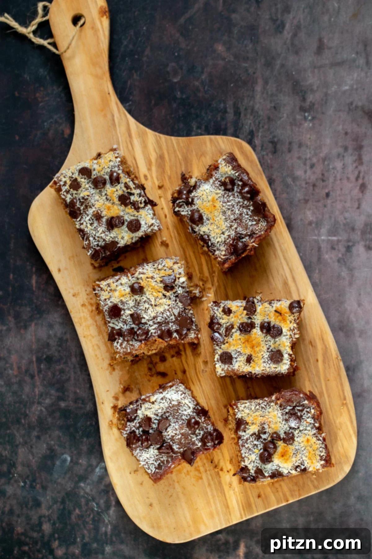 vegan oatmeal date caramel snack bars on a wooden board 