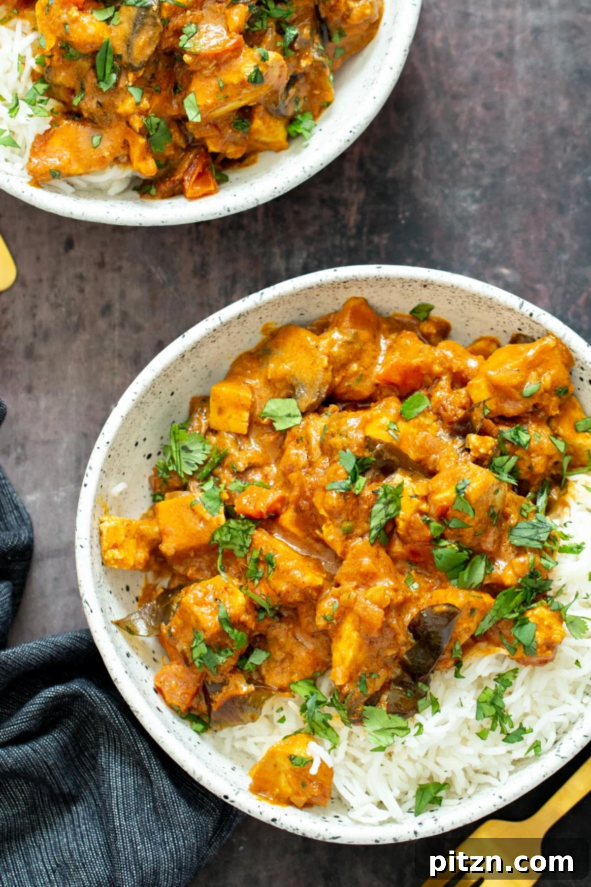 Plate with rice and Indian Tofu Casserole, garnished with fresh cilantro.
