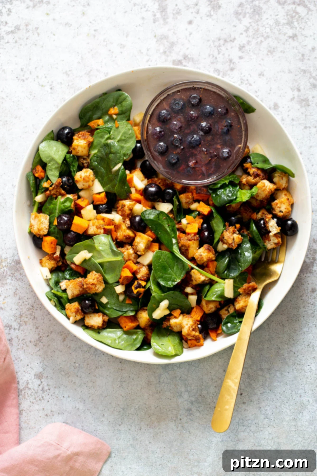 Sweet Potato Tofu Bowl Overhead shot of a vibrant Spicy Maple Mustard Tofu Bowl with roasted sweet potatoes, fresh greens, and a side of blueberry dressing, perfect for a healthy vegan meal.