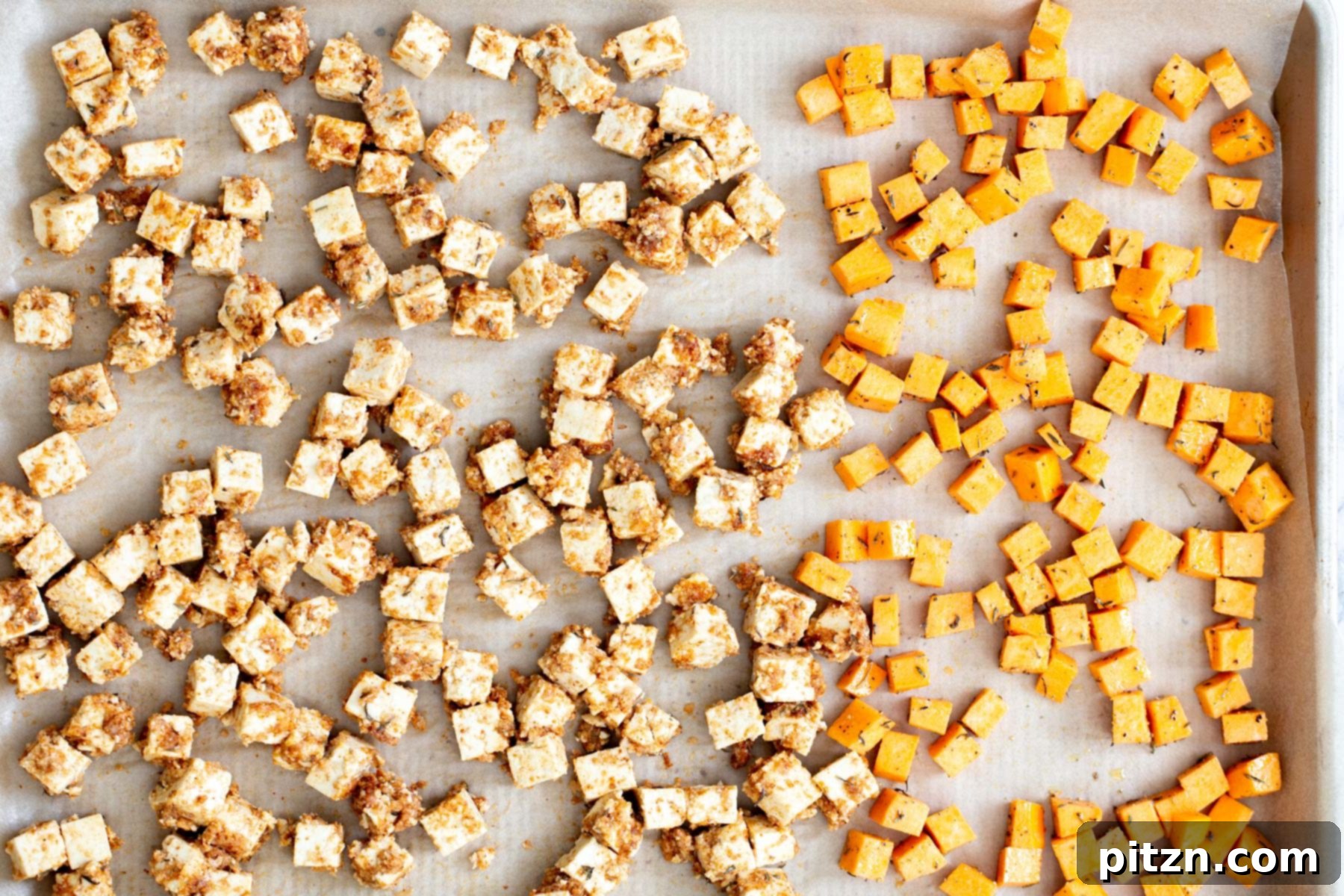 Spicy Maple Mustard Tofu and Sweet Potato Bowl 10 A baking sheet filled with perfectly arranged coated tofu cubes and seasoned sweet potato cubes, ready for the oven to achieve a golden crisp.