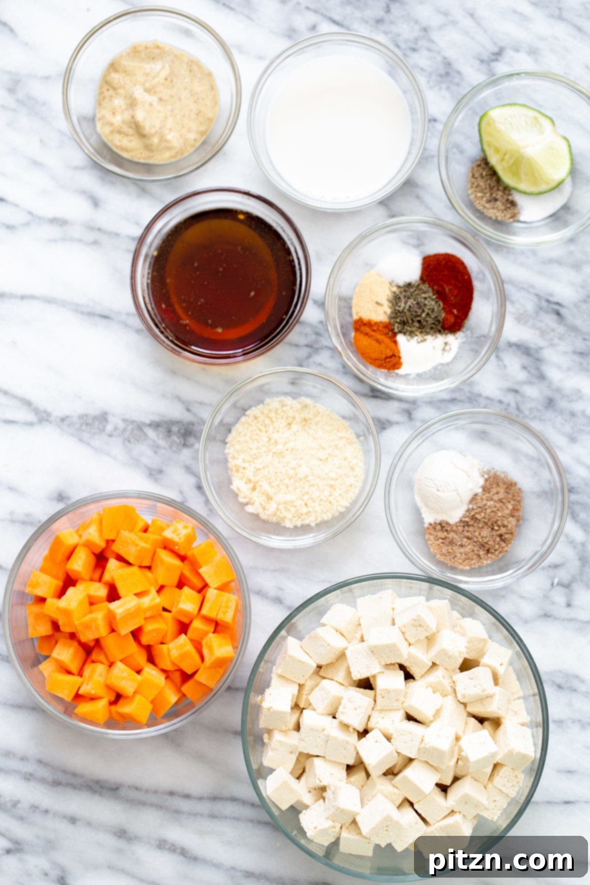Spicy Maple Mustard Tofu and Sweet Potato Bowl 3 An assortment of fresh and prepared ingredients for the Spicy Maple Mustard Tofu Bowl laid out on a clean surface, showcasing the vibrant components before assembly.