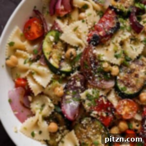 Close-up shot of the summer pasta salad with grilled vegetables, showcasing the delicious details.