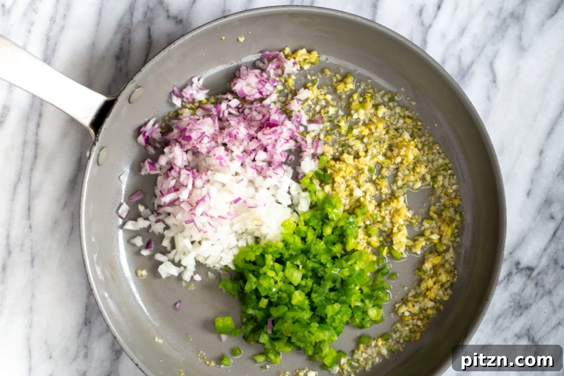 Golden Baked Cauliflower Manchurian 10 Finely minced chili, garlic, ginger, and onions sizzling in a sautéing pan, forming the aromatic base for the Manchurian sauce