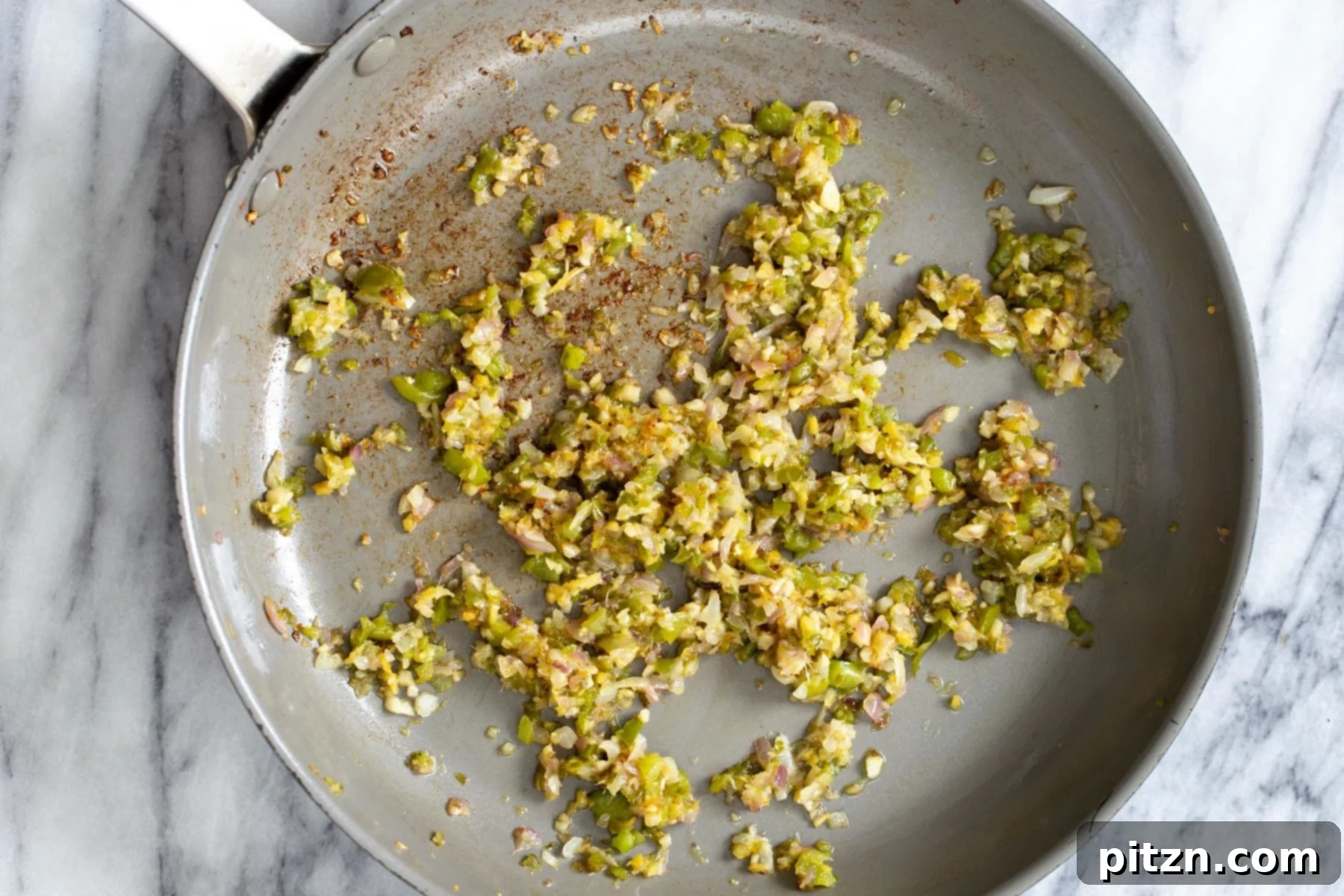 Golden Baked Cauliflower Manchurian 11 Finely minced and sautéed ginger, chili, garlic, and onions glistening in a pan, deepening in color and aroma