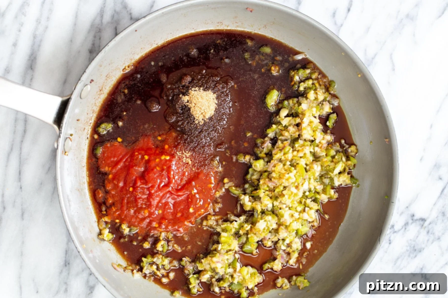 Golden Baked Cauliflower Manchurian 12 All the vibrant ingredients for cauliflower Manchurian sauce simmering together in a saucepan, creating a rich and aromatic liquid