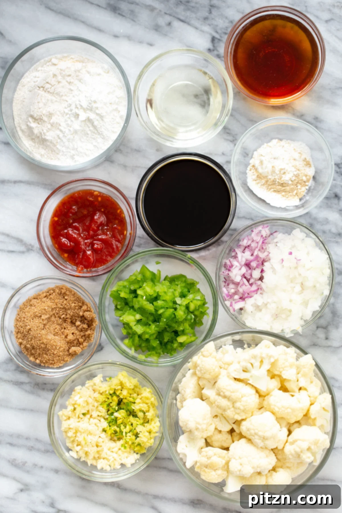 Golden Baked Cauliflower Manchurian 17 A large serving of Baked Gobi Manchurian, glistening with sauce and garnished with fresh green onions