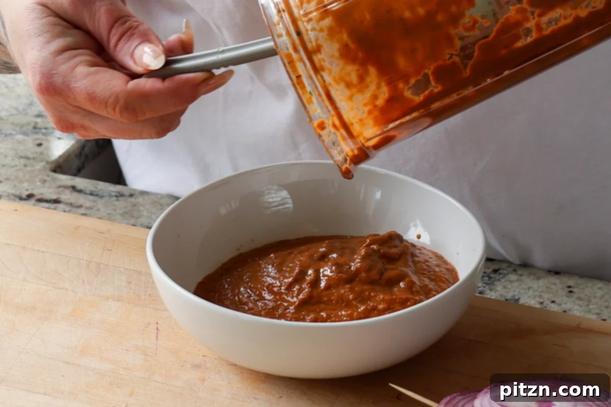 Mediterranean Grilled Veggie with Sun-Kissed Tomato & Basil Pesto 13 transferring sun dried tomato basil spread to a bowl