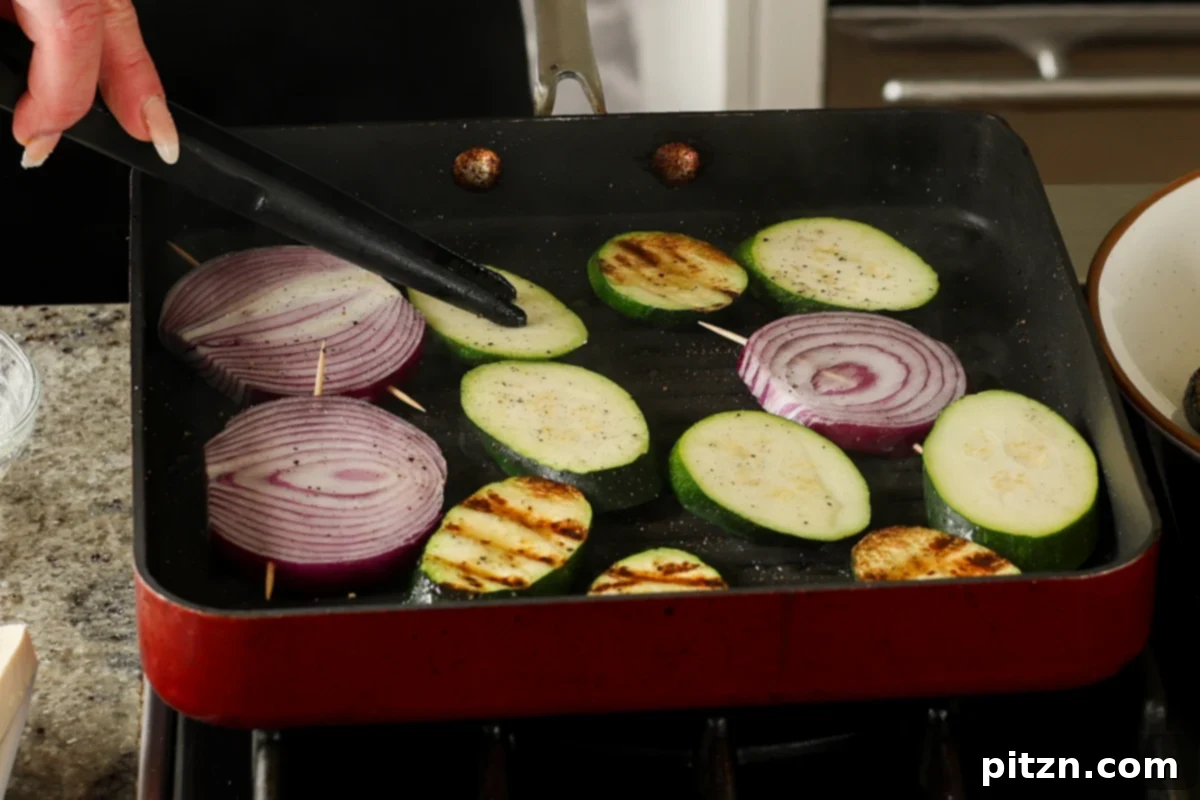 Mediterranean Grilled Veggie with Sun-Kissed Tomato & Basil Pesto 8 grilling the zucchini and onions, with developing char