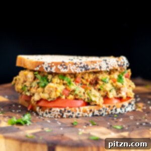 Vibrant Mediterranean Chickpea Sandwich 4 Mediterranean chickpea salad sandwich on a wooden board