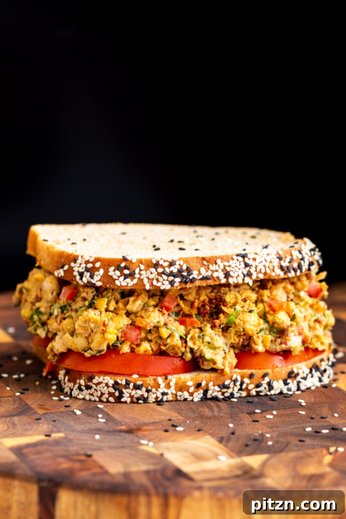 Vibrant Mediterranean Chickpea Sandwich 8 vegan Mediterranean chickpea salad sandwich on multigrain bread served on a wooden board