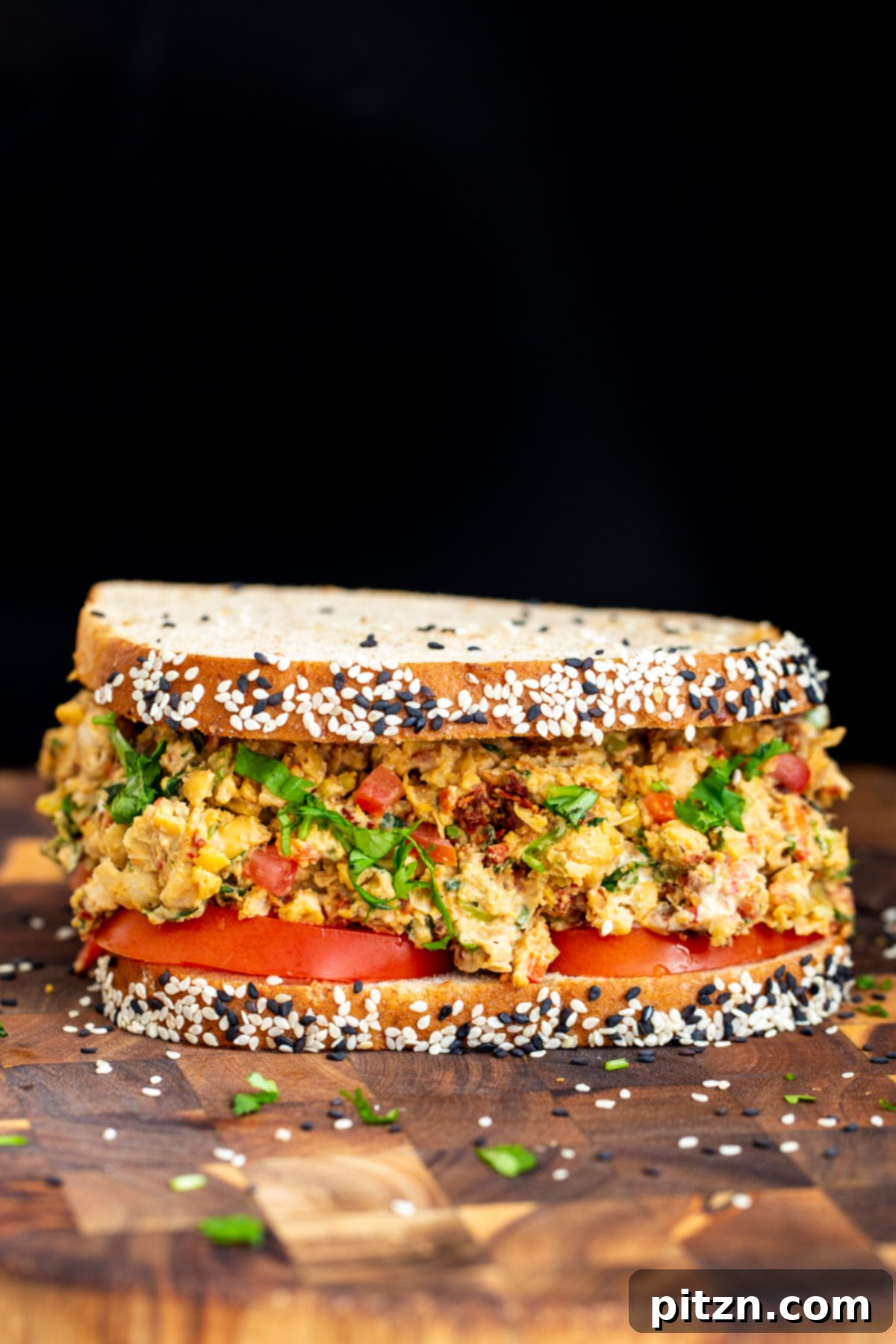 Vibrant Mediterranean Chickpea Sandwich 9 Two Mediterranean chickpea salad sandwiches, one cut in half, showcasing the colorful filling