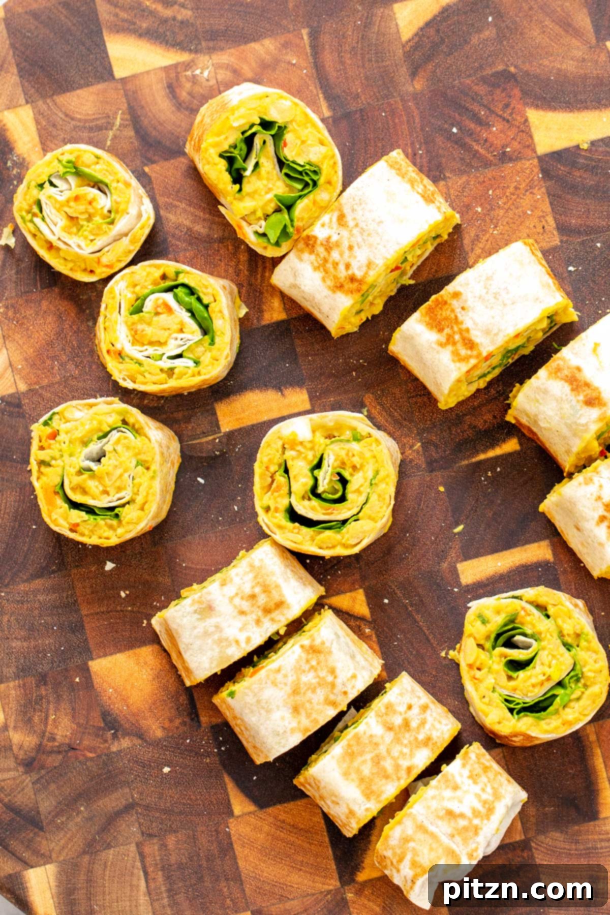 chickpea breakfast vegan chickpea scramble wraps being sliced into pinwheels