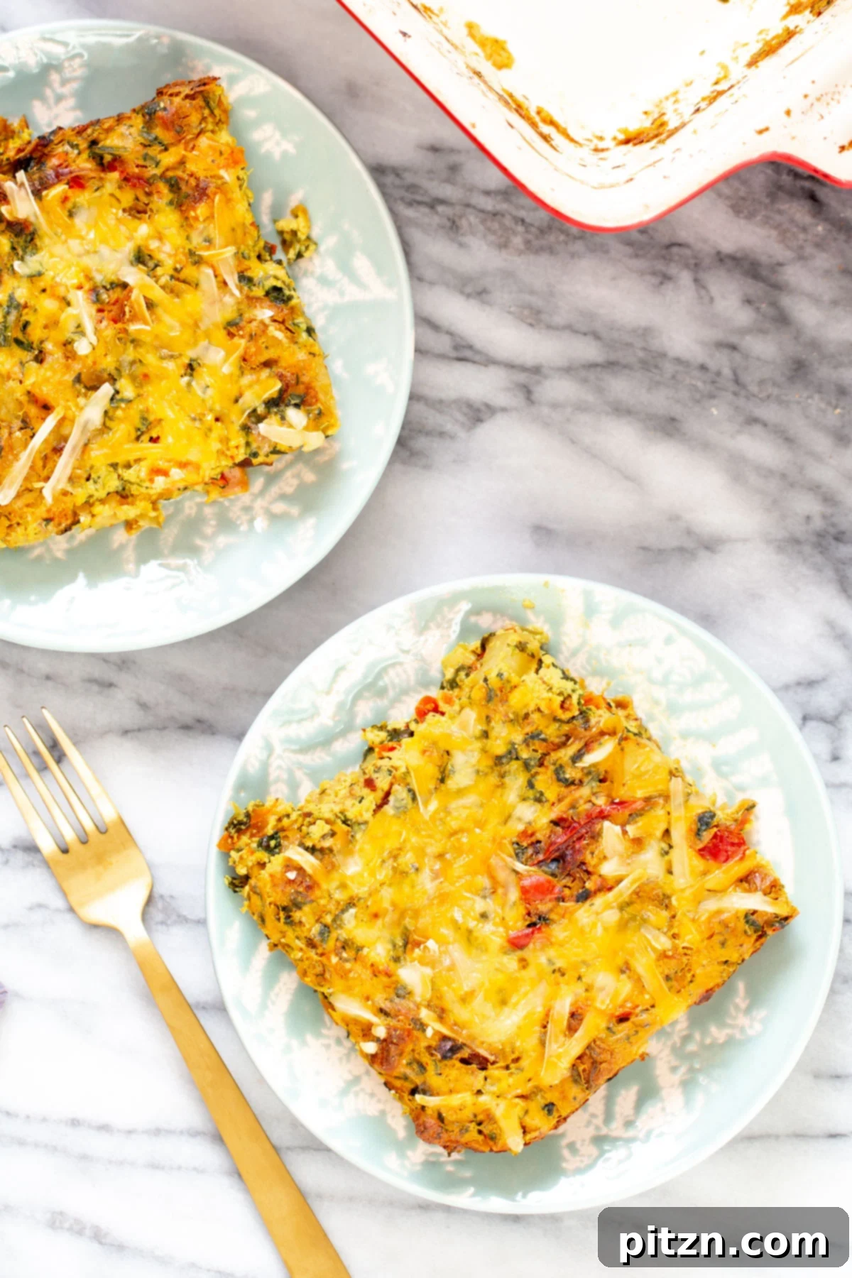 Individual servings of Vegan Mexican Egg Casserole, highlighting the fluffy tofu eggs, vibrant vegetables, and cheesy topping.