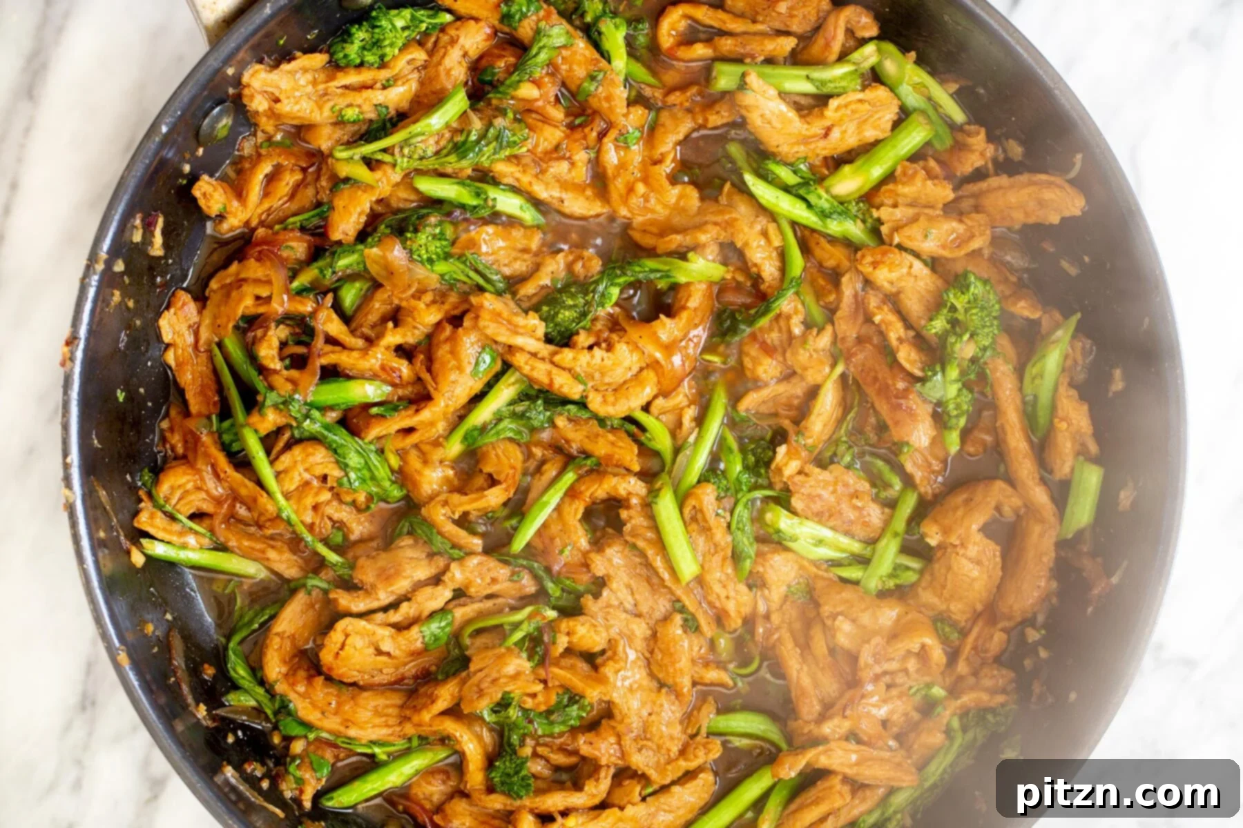Soy curls, broccolini, and fragrant Thai basil stir-fried together in a pan, infused with the rich sauce