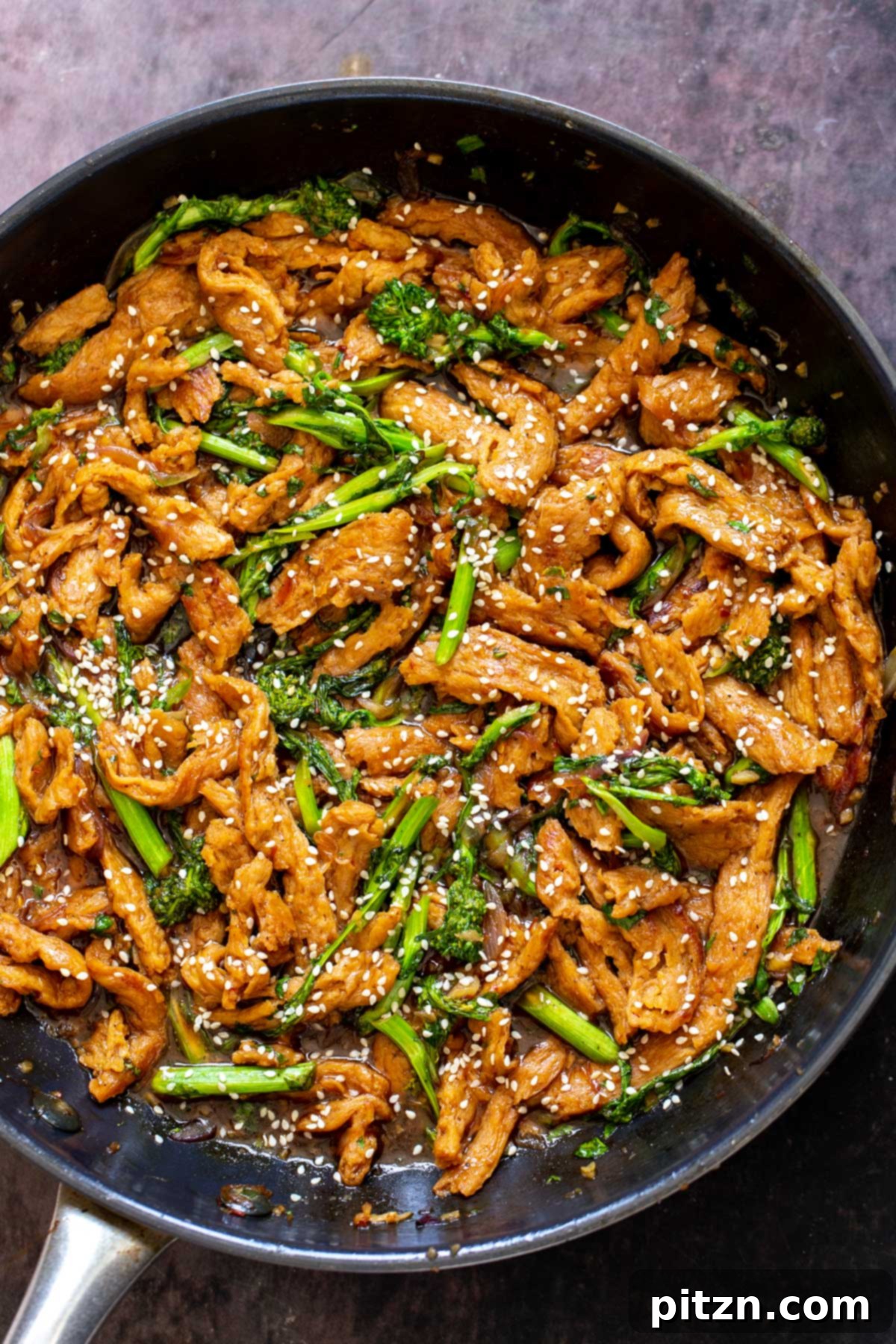 Close-up of an Asian soy curl stir fry, richly colored and sprinkled with sesame seeds, ready to be served