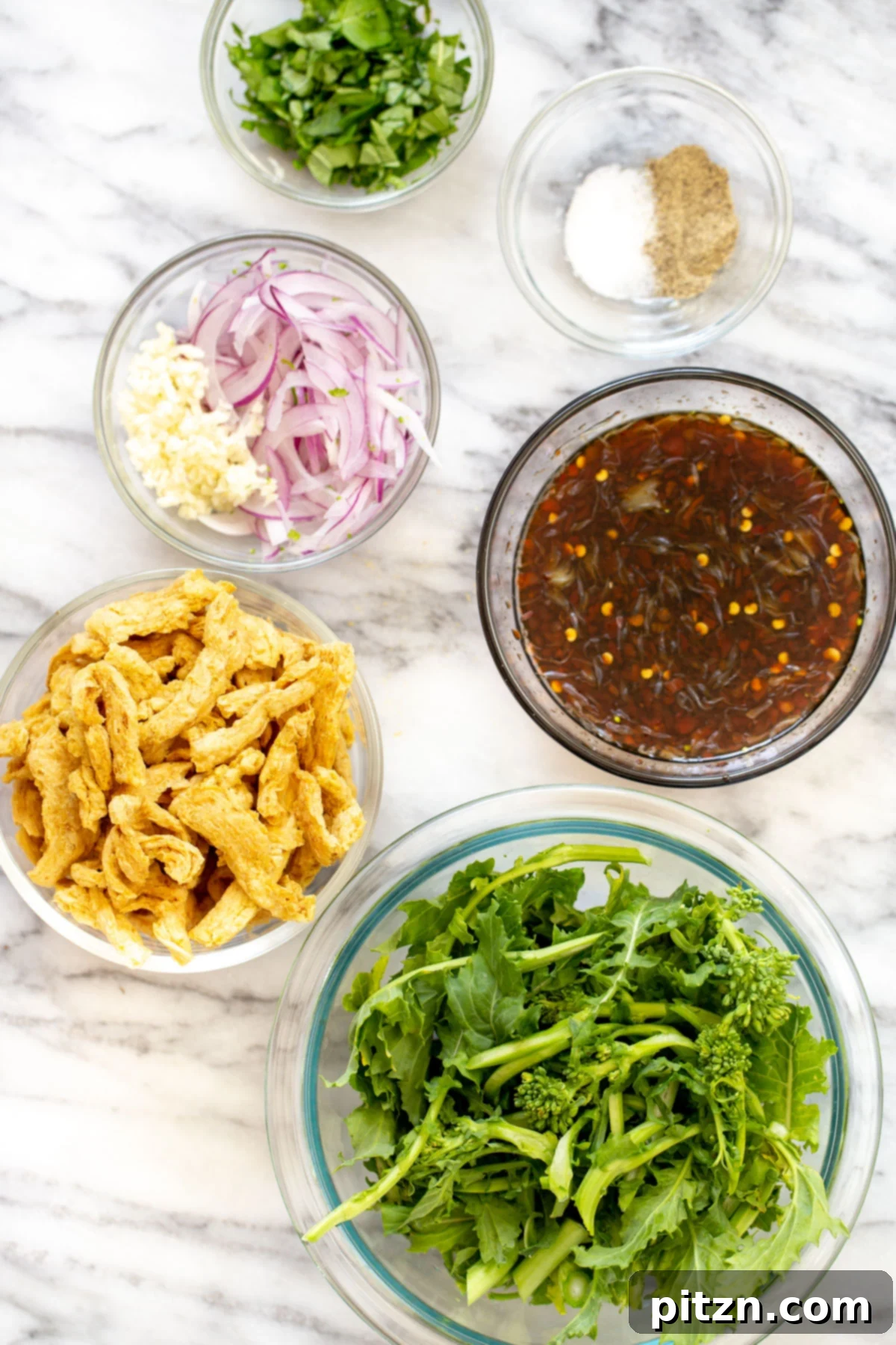 A collection of ingredients laid out on a kitchen counter, ready for the sesame soy curl stir-fry recipe preparation