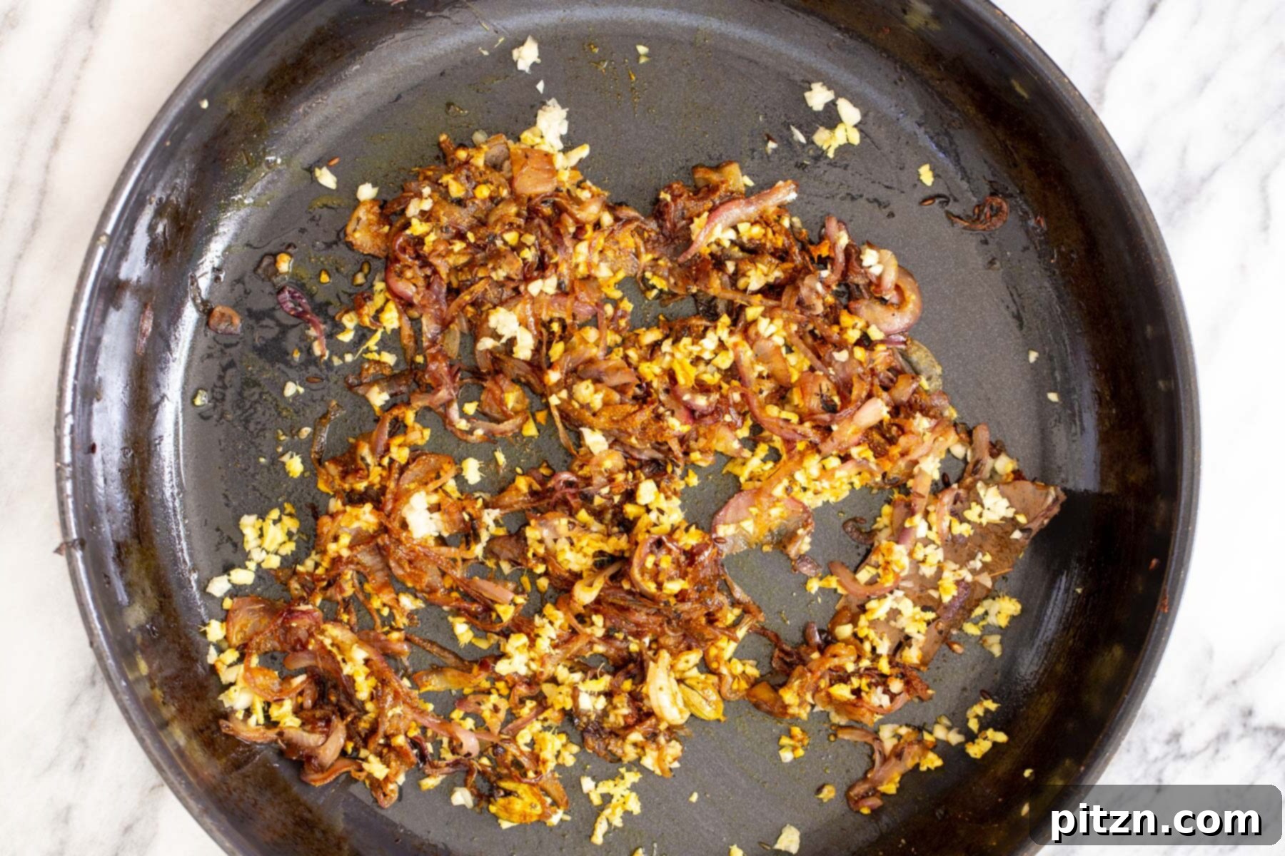 Rich Double Onion Cauliflower 11 The perfectly fried onions, ginger, and garlic, now thoroughly blended with spices, simmer gently in a saucepan, forming the aromatic foundation of the curry.