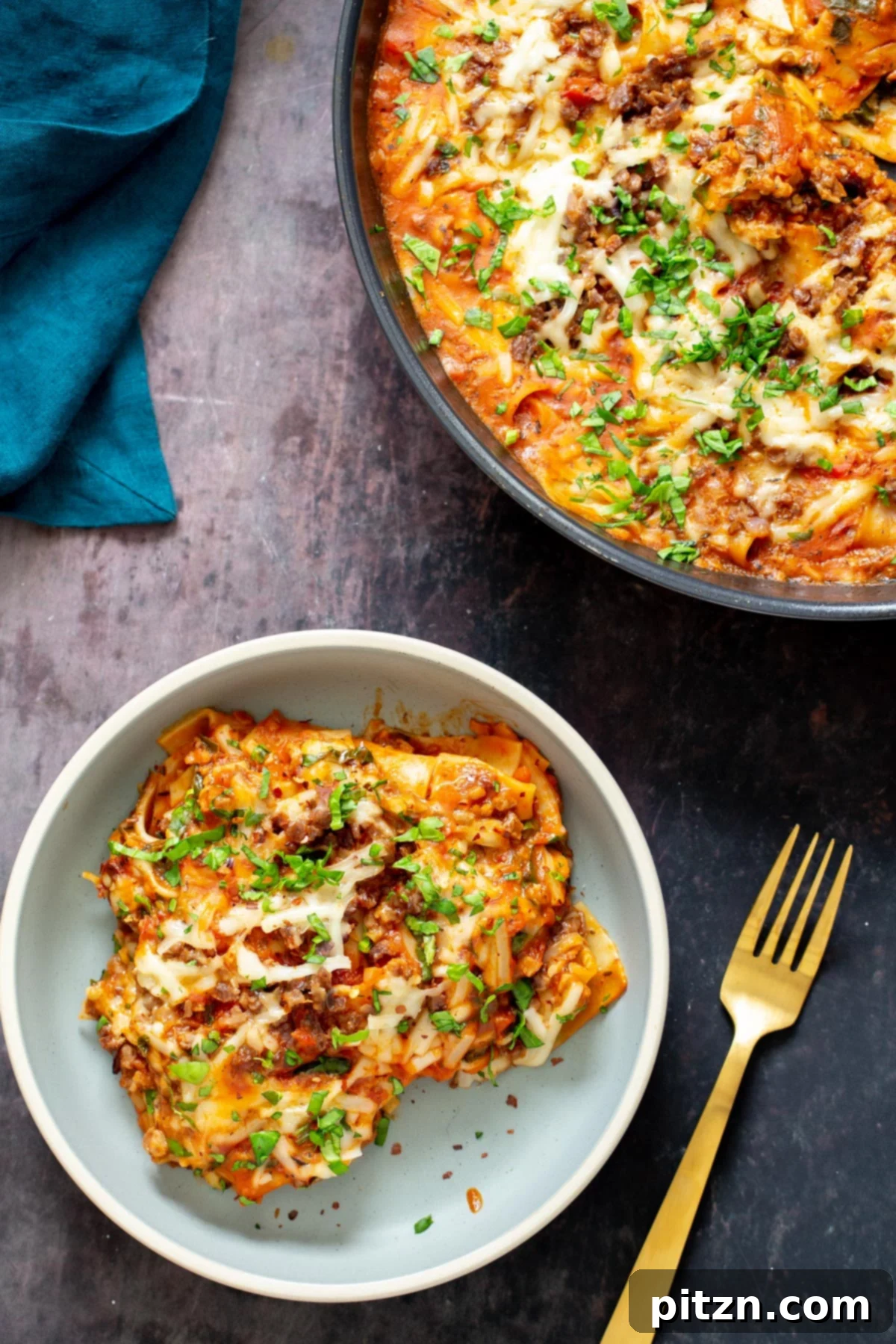 Hearty Vegan Skillet Lasagna 13 A perfectly portioned serving of vegan cast iron skillet lasagna, garnished with fresh green herbs, presented beautifully for a comforting meal.
